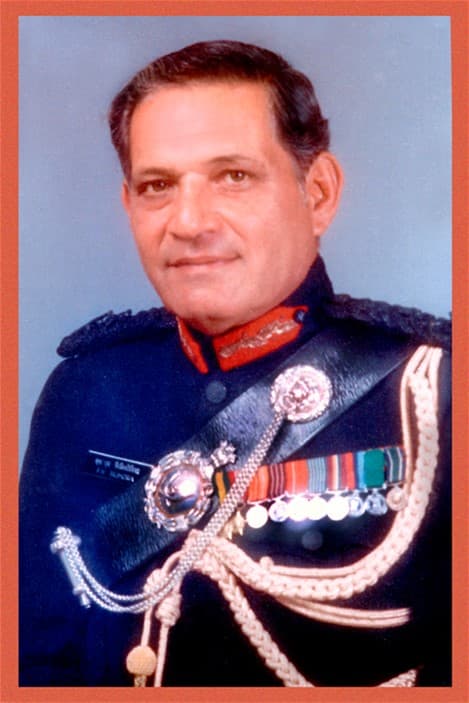Lieutenant General Faridoon Bilimoria (center) standing in full ceremonial military uniform, flanked by two high-ranking officers.