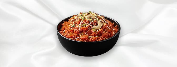 Carrot Halwa — Warm carrot fudge infused with cardamom and studded with nuts and raisins served with ice cream..GF, GB Cantee