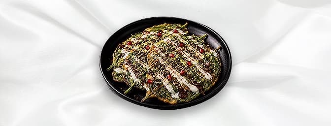 Palak Patta Chaat — British samphire and crispy battered baby spinach leaves with chilli, turmeric, fresh coriander, dressed 