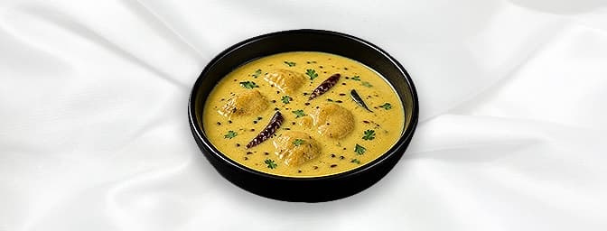 Punjabi Kadi — Homestyle tempered yoghurt curry laced with chickpea flour, turmeric, spices and simmered with vegetable dumpl