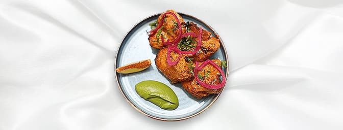 Chicken Tikka — Chicken marinated in yoghurt, crushed garlic, mixed with a blend of mild spices, and barbecued over charcoal.