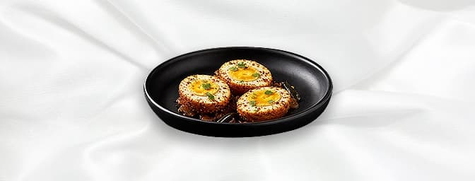 Kottayam Egg Fry — Batter fried boiled Egg, tossed in onion and tomato spices, flavoured with ginger, curry leaves, seasoned 