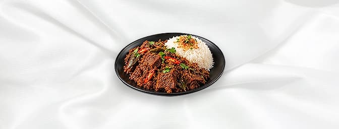 Rendang Beef — Slow cooked beef with aromatic spices such as roasted coconut, bay leaves, galangal, chili, onions, ginger, st