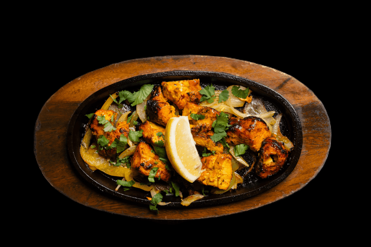 Tin Rang Murgh — This starter is very colourful and popular. Three different types of marinated chicken served with salad, GB