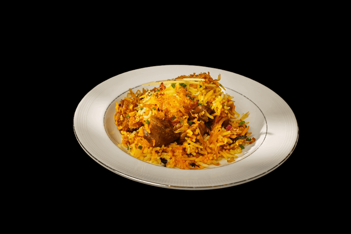Lamb Biryani — All Biriani dishes are stir fried with basmati rice to our own recipe and served with a vegetable curry, GB Ca