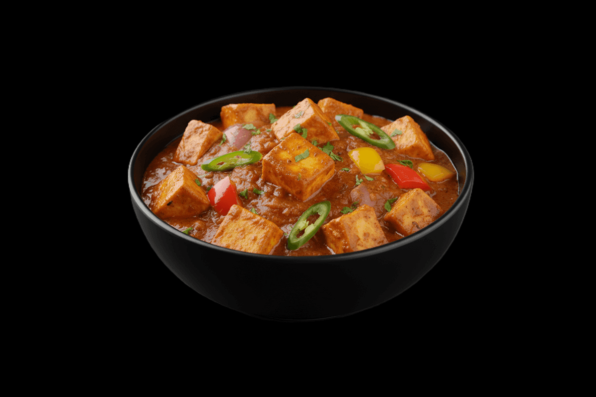 Paneer Jalfrezi — Paneer topped with toasted garlic, peppers, and aromatic spices. Paired with a dry, thick sauce that is und