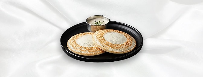 Appam — Appam is the soft pancake made from yeast fermented rice batter, with a soft spongy middle, which is laced with crisp