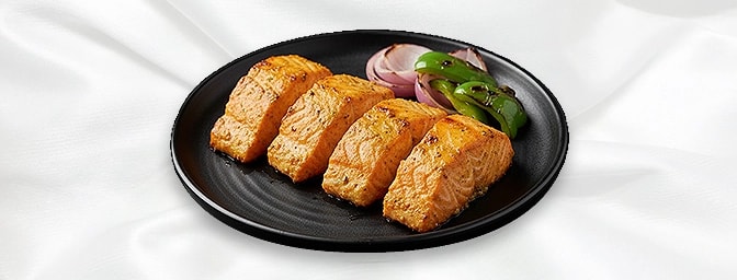 Tandoori Salmon — Carom seeds, dill, spices and lime marinated fillets of salmon grilled and cooked to perfection in the tand