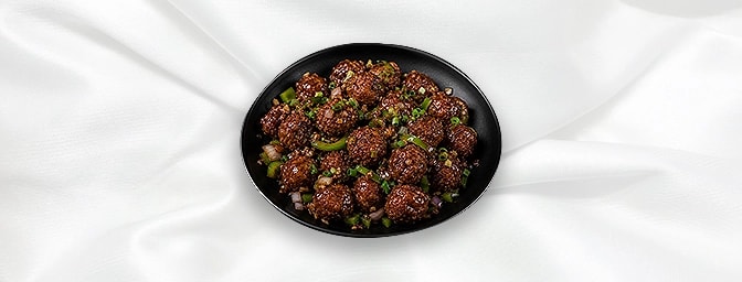 Veg Manchurian Dry — A wonderful Indian creation of mixed vegetable fritters, fried and topped with a robust ginger, Garlic c