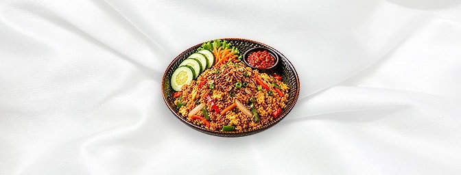 Nasi Goreng — Indonesian fried rice with egg, mixed peppers, onion, carrot, garnished with cucumber, shallot and sambal sauce