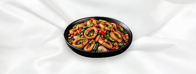 Hakka Squid — A robustly semi dry dish, stir-fried with spring onions, hot green chillies, chopped garlic and light soya sauc