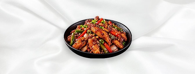 Tai Pai Chicken — Famous Indo-Chinese style, chicken strips with red chilli flakes, green and red peppers, finished with chef