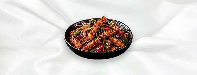 Tai Pai Paneer — Famous Indo-Chinese style, small finger panner with red chilli flakes, green and red peppers, finished with 