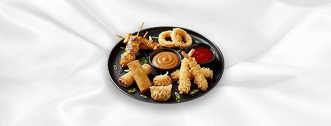 Mixed Platter — Chicken Satay, Calamari, Prawn Tempura, Vegetable Spring Rolls & Dim Sum served with peanut & sweet chilli sa