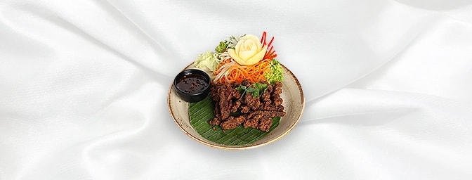Crispy Spiced Beef — Strips of Beef marinated with Thai spices � batter fried and served with a spicy and sweet tamarind jam 