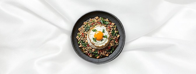Pad Kra Poo — Stir-fried spicy minced Chicken with Thai basil � served with rice and a fried egg on top, GB Canteen Newington