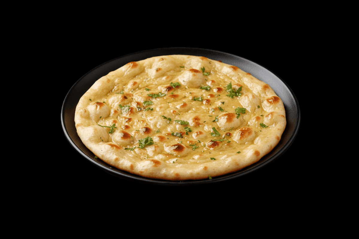 Butter Naan — Leavened bread, in its original form. Baked to a light crunch in the tandoor and generously topped with butter,