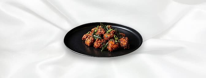 Chicken 65 — Like the CTM in the UK, this dish enjoys iconic status in India. Andhra style fried chicken with a tangy coating