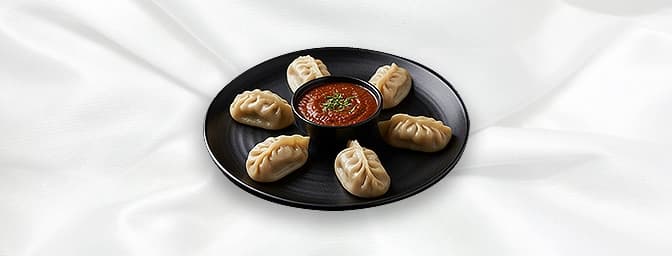 Chicken Momo — Steam / Chilli Traditional Nepalese dumplings , either delicately steamed with house chutney or wok tossed wit