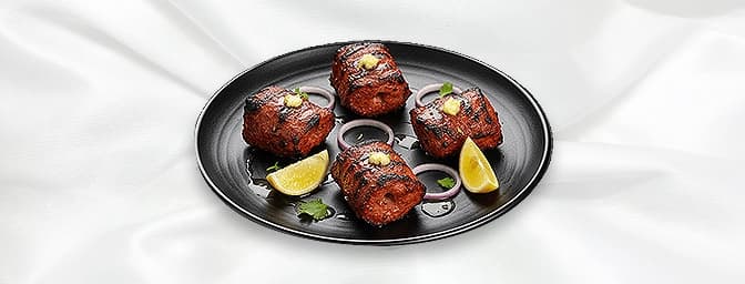 Lamb Tikka — Boneless pieces of lamb marinated in mixed spices grilled in a clay oven, GB Canteen Farnham