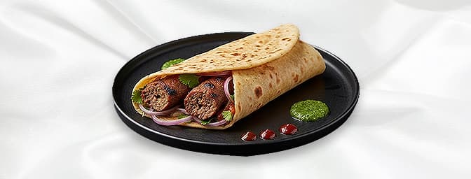 Lamb Seekh Kebab Wrap — Lamb Seekh kebab, served on naan bread, alongside fresh salad, and a special range of Haweli sauces,
