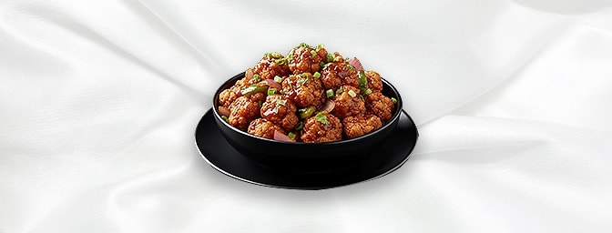 Cauliflower Manchurian — Cauliflower mixed with corn flour batter, pan fried, tossed with onion & capsicum, GB Canteen Tootin