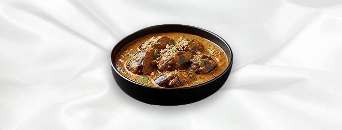 Kathrika Koottan — Aubergines cooked in a paste of coriander seeds, roasted onions, chillies mixed with cashew nut sauce, GB