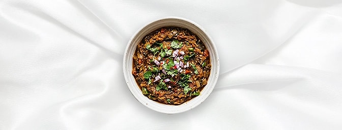 Baingan Bharta — Smoky, Rich & Comforting Dive into our authentic Baigan Bharta�fire-roasted eggplants charred over an open f