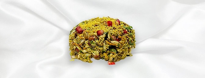 Bhel Poori — Experience a symphony of textures in this iconic Mumbai staple. Light, crispy rice puffs are expertly tossed wit