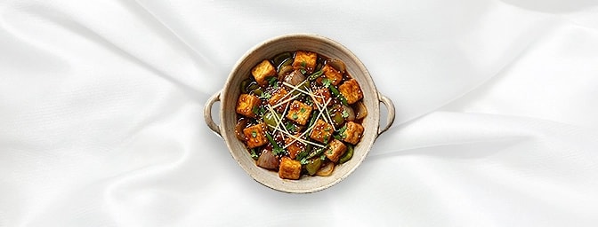 Chilli Paneer with Idli — An Indo-Chinese fusion masterpiece. Wok-tossed cottage cheese in a spicy chilli-garlic glaze with s