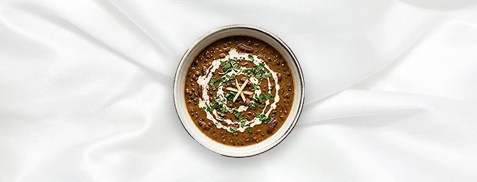Dal Makhani — Indulgence in every spoonful. Black lentils are slow-cooked overnight on the tandoor to achieve a legendary smo