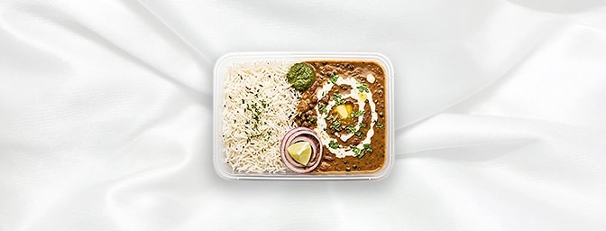 Dal Makhni Rice Bowl — Featuring slow-cooked black lentils simmered overnight on the tandoor and finished with velvet cream.