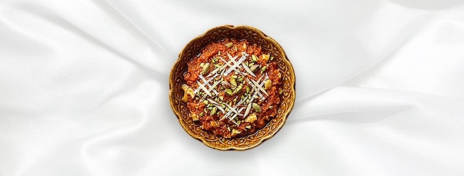 Gajar Halwa — A luxurious, traditional Indian dessert to round off your meal. This slow-cooked carrot pudding is simmered wit
