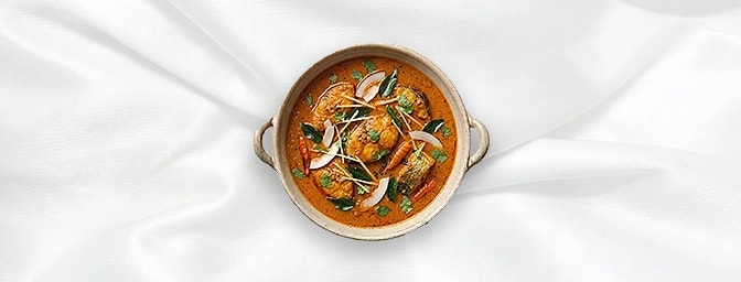 Goan Fish Curry — A quintessential taste of Goa. Flaky fish is bathed in a luxurious coconut milk sauce, expertly tempered wi