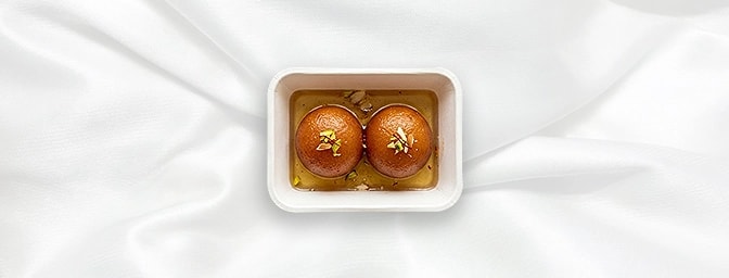Gulab Jamun — The ultimate grand finale. These delicate, golden-fried milk dumplings are soaked in a warm, fragrant sugar syr