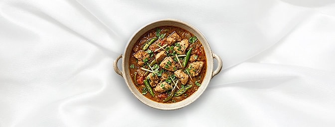 Karahi Chicken — Experience authentic Punjabi bold flavors. This robust dish features tender chicken wok-seared with fresh gi