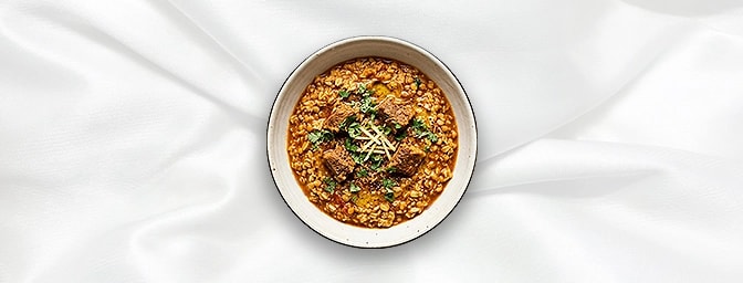 Lamb Khichdi — A sophisticated, heart-healthy twist on comfort food. Tender lamb is slow-cooked with wholesome oats and aroma