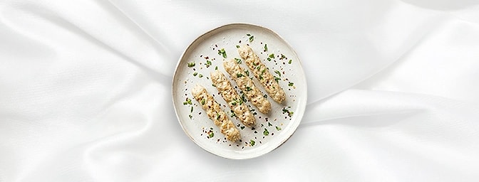 Murgh Malai Kebab — The height of poultry sophistication. Tender chicken breast is marinated in a silky, luxurious mixture of