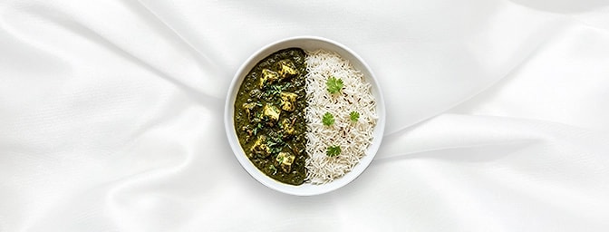 Palak Paneer Rice bowl — A harmonious duo of velvety, creamed spinach and soft cottage cheese cubes tempered with cumin and g