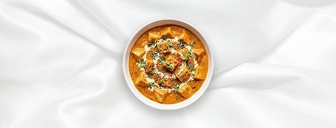 Paneer Makhani — Pure vegetarian luxury. Velvety cubes of paneer are swathed in a mild, silky-smooth gravy crafted from butte