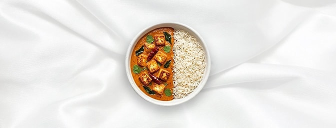 Paneer Makhni Rice Bowl — Treat yourself to tender paneer cubes simmered in a mild, velvety cashew and tomato gravy. Served a