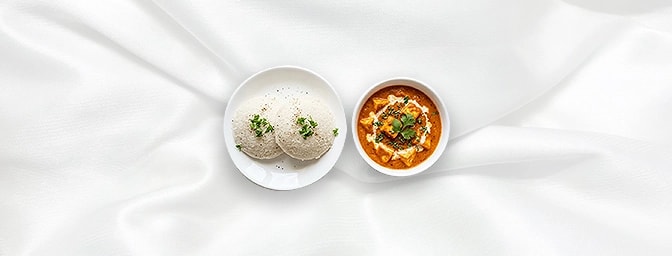 Paneer Makhni with Idli — Indulge in pure silk. Velvety cubes of paneer in a mild, creamy cashew and tomato gravy, elegantly