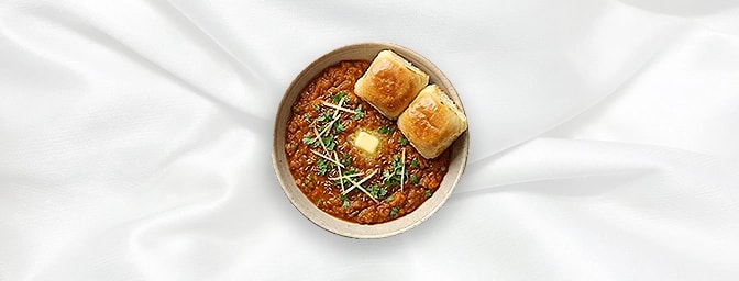 Pao Bhaji — A beloved Mumbai street classic featuring a medley of spiced, mashed vegetables slow-cooked to buttery perfection