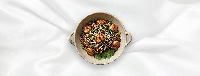 Prawn Noodle Bowl — Succulent prawns stir-fried to perfection with thin egg noodles, crisp spring onions, and a splash of sav