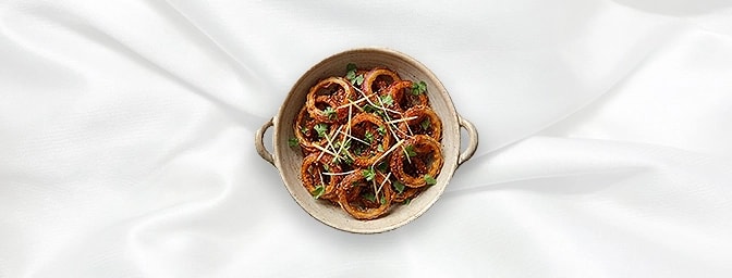 Punjabi Lachcha Pyaz — Onion rings tossed with spicy chutney, lemon juice and red chilli powder. Traditional red onion rings