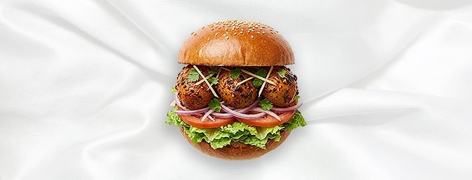 Tandoori Aloo Burger — Savor the smoky depths of grilled baby potatoes seasoned with traditional tandoori spices. Layered wit