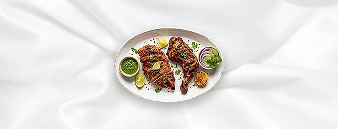 Tandoori Chicken — The undisputed king of the clay oven. Experience half a succulent chicken on the bone, marinated in a robu