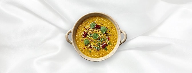 Tarka Dal - Taster — A delicate small-plate version of our golden yellow lentils. Tempered with toasted cumin, saut�ed onions