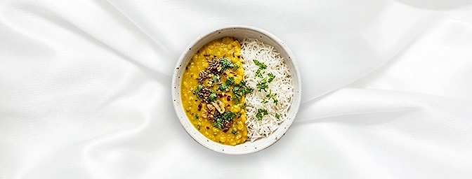 Tarka Dal Rice Bowl — Comfort in a bowl. One half features fragrant, fluffy Basmati rice, while the other holds our soul-warm