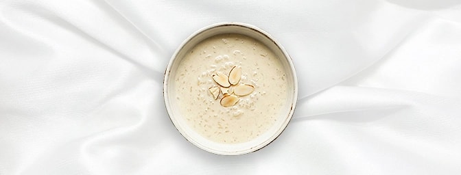 Almond Kheer — A luxurious twist on a classic. Our traditional chilled rice pudding is layered with the sun-kissed tang of st